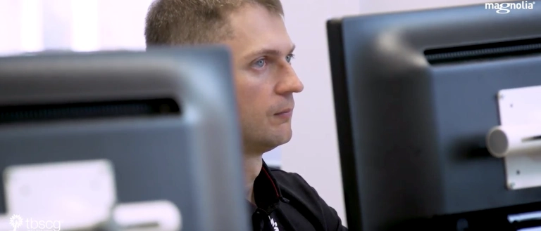 Man staring at two computer screens